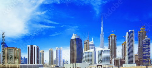Modern Dubai skyline with Burj Khalifa, downtown city center, luxury skyscrapers and waterfront bay in the United Arab Emirates, panoramic urban cityscape and famous travel destination in the Middle E