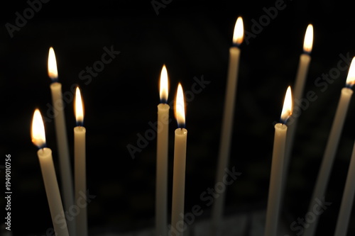 Burning candles in the dark chamber room of a church