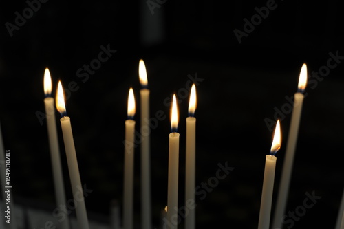 Burning candles in the dark chamber room of a church