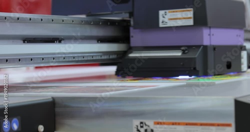 Modern Digital Large format UV printer. Printing production technologies. UV pinning is the process of applying a dose of low intensity ultraviolet light to a UV curable ink