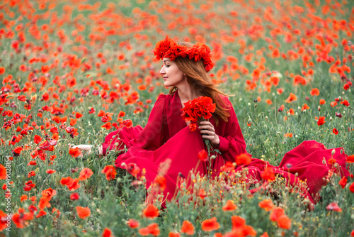 Woman red dress poppy field enjoys summer nature photography