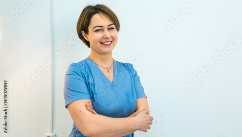 Smile, crossed arms and face of woman nurse. Happy, medical career and portrait of young caucasian female healthcare worker with confidence in nursing facility