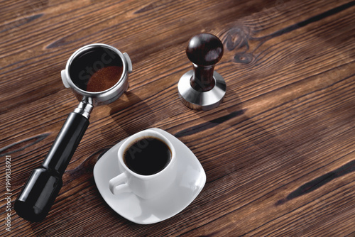 Принти на полотні a cup of coffee, a coffee horn and a tamper on a wooden background close-up,  se