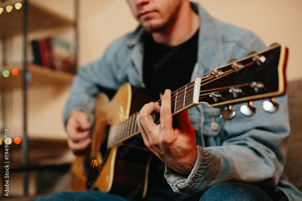 Obraz premium Musician composing music playing acoustic guitar at home