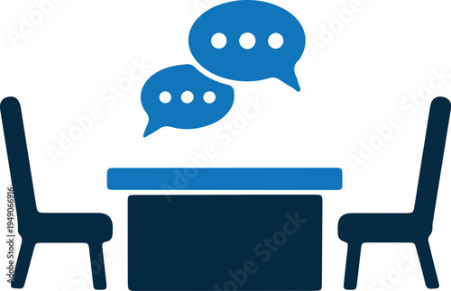 Two individuals engaged in a conversation at a small table with chairs