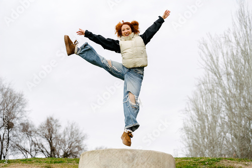 Young woman expressing joy in an urban outdoor setting