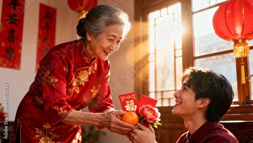 Heartwarming family moment of an elderly Asian grandmother giving a traditional red envelope to a child during Lunar New Year. The red packet symbolizes blessings, luck, and prosperity in Chinese New 