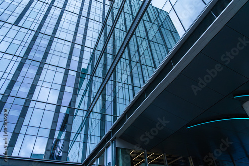 Modern glass office building with blue facade