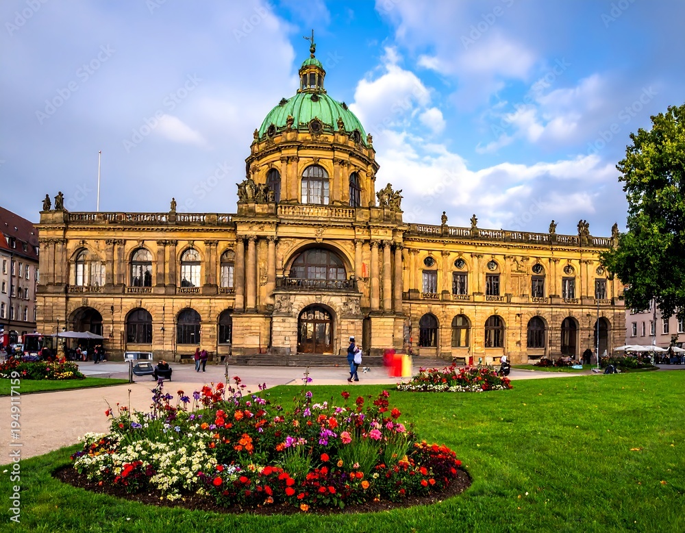Fototapeta premium Large, classic, stone building with a green dome and flowerbeds