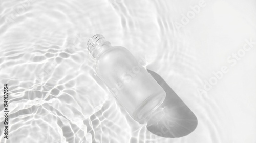 Konstfotografi Blank frosted glass bottle floating in clear rippling water, hydrating skincare mockup