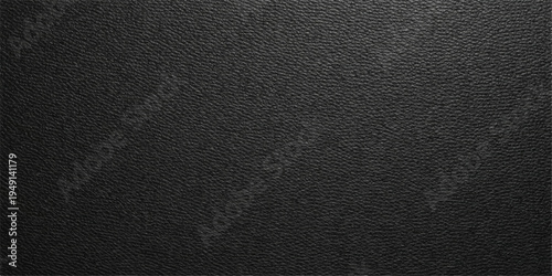 A macro closeup of a dark black leather texture background reveals a rough material surface with an old, textured skin pattern for a grey textile backdrop