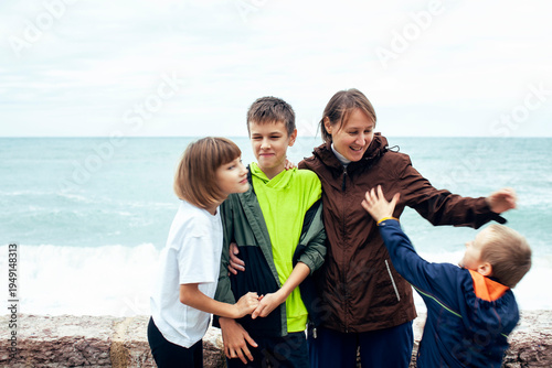 mother with children shooting on phone outside, happy memory, lifestyle people concept