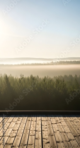 Wooden deck overlooking a misty forest landscape at sunrise