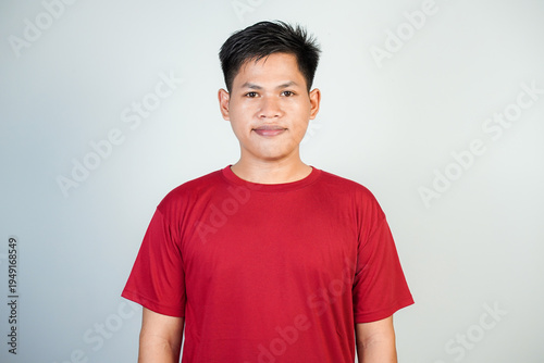 Young Asian Man Portrait in Red T-Shirt Smiling Against Neutral Studio Background