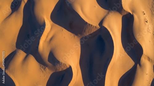 Aerial View of Expansive Sand Dunes Capturing Intricate Patterns and Textures Under Golden Sunlight