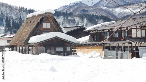 natural landscape view to gassho zukuri house style in Shirakawago village with white snow covered all area in the village in winter snow sunny time.famous landscape countryside winter snow village