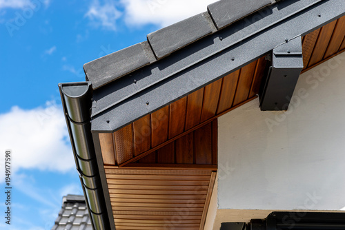 Building roof detail featuring soffit, gutter, and flashing installation