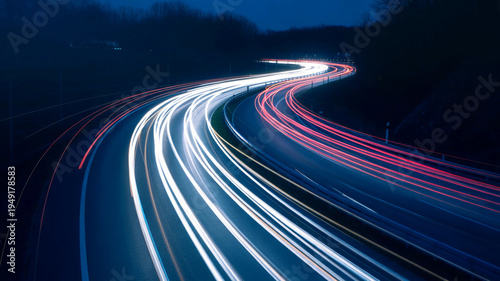 Dynamic long exposure light trails on a dark highway at twilight