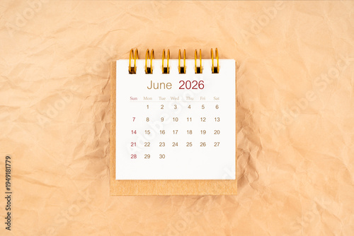 June 2026 mini desk calendar on old brown paper.