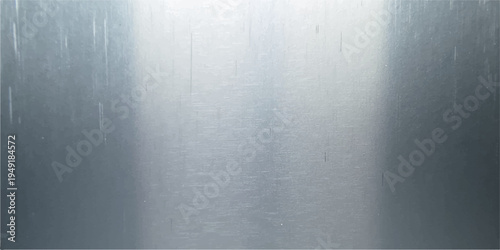 A polished stainless steel plate features a brushed metal texture with a shiny silver pattern reflecting light across the dark gray metallic surface of this industrial aluminum backdrop material