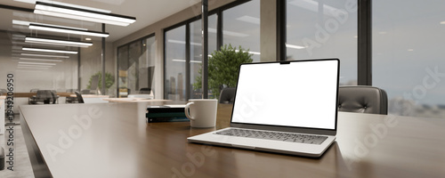 Computer Laptop with blank screen on table inside modern glass meeting room 3D render