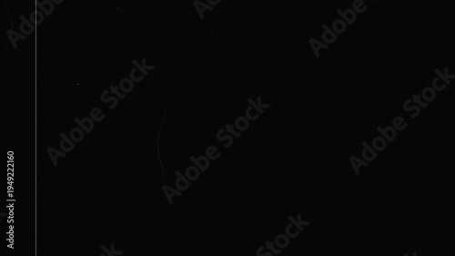 Old film tape defects visual on black background with flickering grain, scratches, and analog distortion, ideal for vintage style video and film project 4K resolution.
