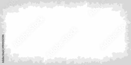 A white rectangular shape framed by a roughly torn gray border