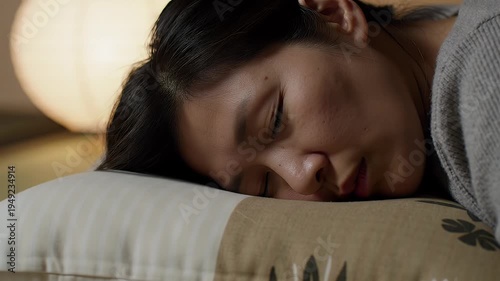 Close Up Of A Young Woman Sleeping Peacefully On A Pillow With Soft Lighting And A Blurred Background Representing Rest And Tranquility