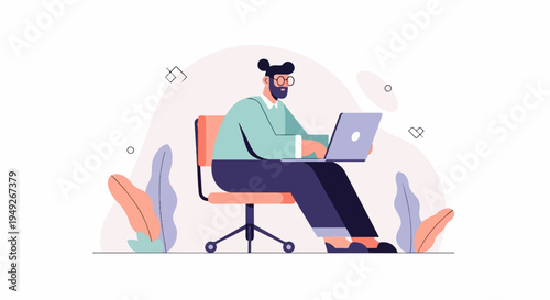 Bearded man with glasses working on a laptop at his desk