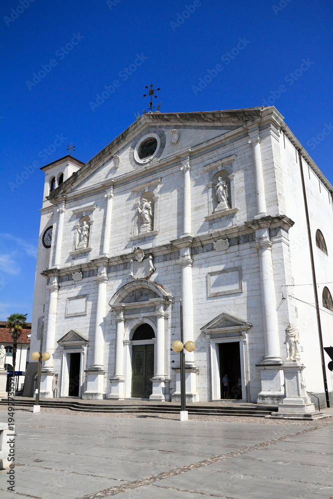 Fototapeta premium Grand white church exterior against blue sky, Palmanova, Italy