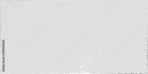 A minimally textured light gray surface with a small white speck