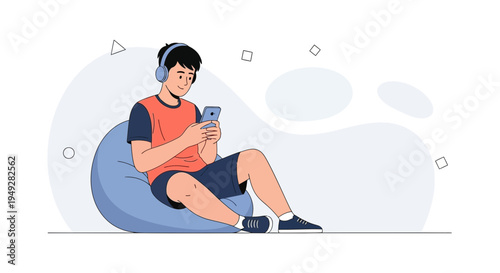 Young man with headphones using smartphone while sitting on bean bag chair, enjoying music