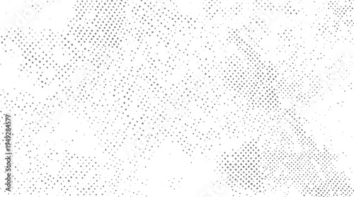 Grey dots pattern on white background with varying density and size abstract texture