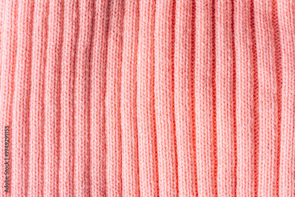 Fototapeta premium Pink ribbed knit texture background, knitted fabric surface close up.