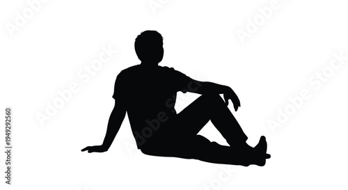 A relaxed man leaning against a surface in stark silhouette