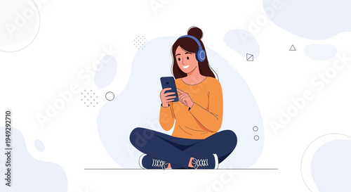 Young woman listening to music on headphones and using her smartphone, sitting cross-legged.