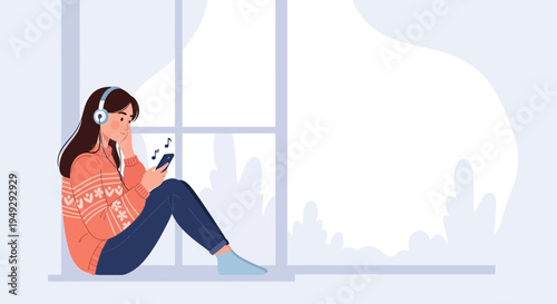 Young woman listening to music on headphones with smartphone by window