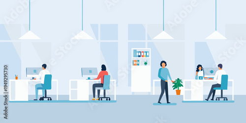 Modern office space with employees working at desks and collaborating