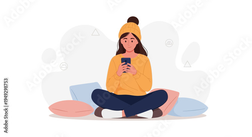 Young woman in beanie and sweater using smartphone, sitting on floor with pillows