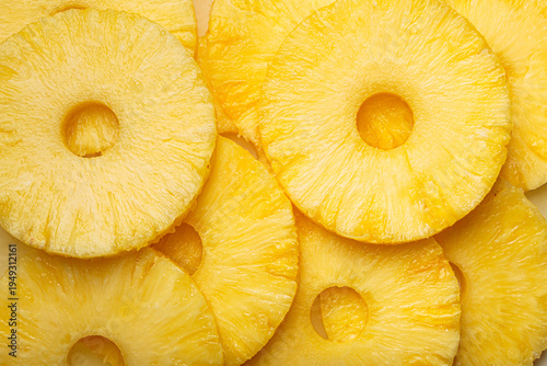 Sliced pineapple rings close up macro vibrant yellow background vitamins fruit