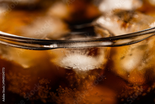 Macro Top View of Cola Drink with Ice Cubes and Bubbles