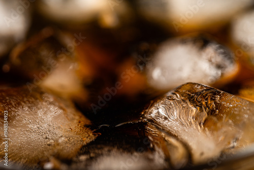 Macro Top View of Cola Drink with Ice Cubes and Bubbles