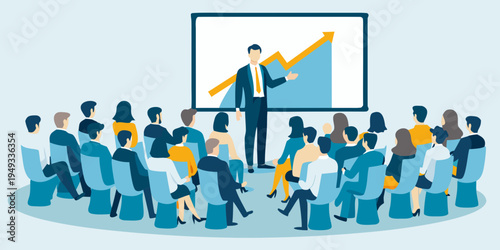 A business presenter leads a meeting with an attentive audience