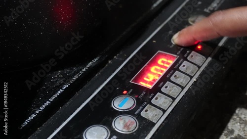 Women use induction cookers by placing compatible magnetic cookware on the cooking zone