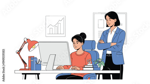 Senior manager standing behind a female employee who is focused on working at her computer desk in an office.