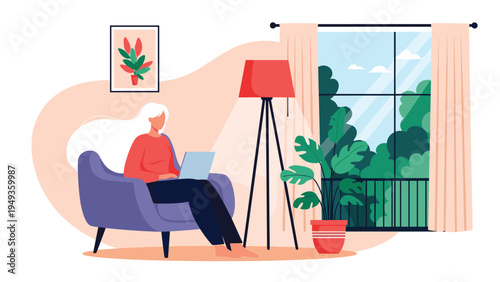 Woman with long white hair working on her laptop while sitting in a cozy armchair near a large window with a view.