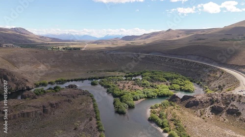Aerial 4K view of the Limay River Amphitheater near Bariloche. Cinematic drone footage of the horseshoe bend river and steppe landscape in Neuquen and Rio Negro, Patagonia Argentina.