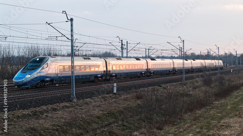 A fast intercity train runs on tracks in Poland.