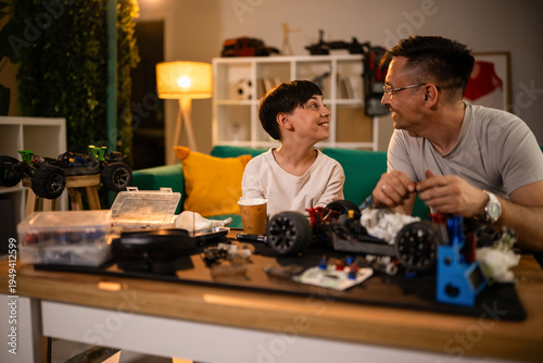 Foto Father and son bonding sharing remote control car hobby
