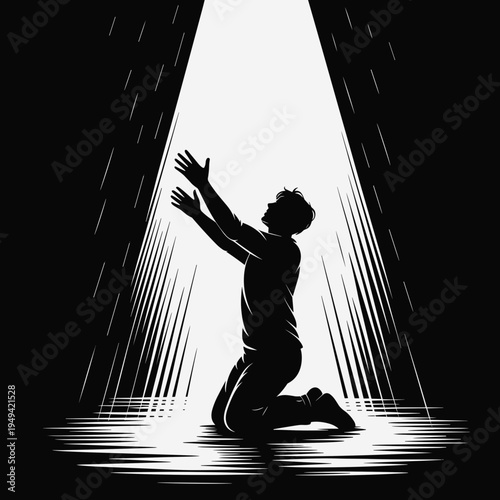 Man kneeling with outstretched arms in light rays against dark background  
